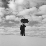 Businessman with Umbrella in Desert Businessman with Umbrella in Desert