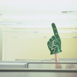 Businessman in Cubicle Raising Foam Hand