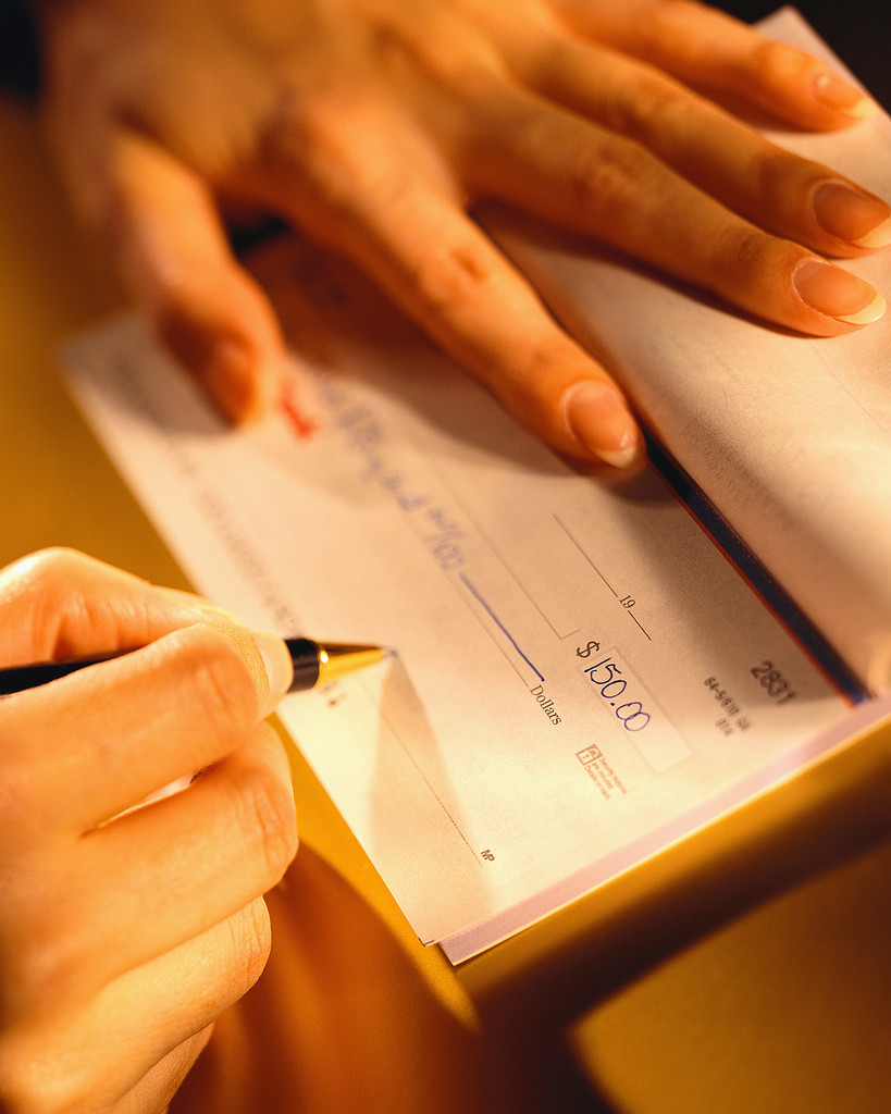 Woman Signing a Check